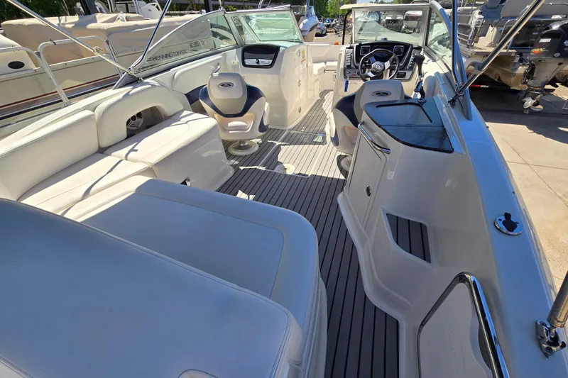 Slide: The Image of 2010 Chaparral Sunesta 224 boat interior with seating and steering console. - 21