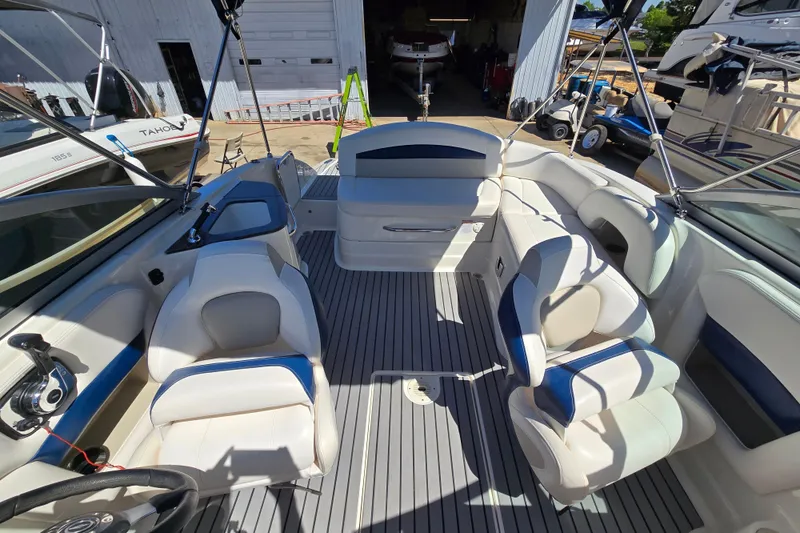 Slide: The Image of 2010 Chaparral Sunesta 224 boat interior with white seating and gray flooring. - 22