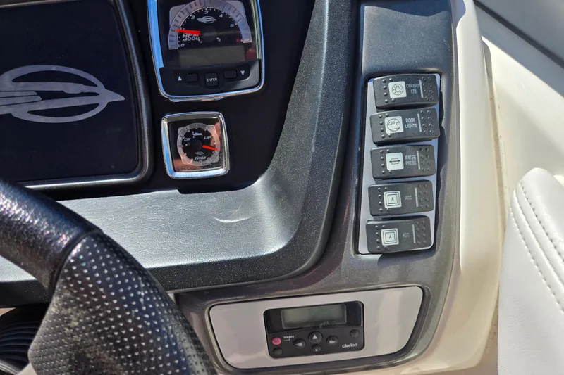 Slide: The Image of Dashboard controls of a 2010 Chaparral Sunesta 224 boat, featuring gauges and switches. - 26