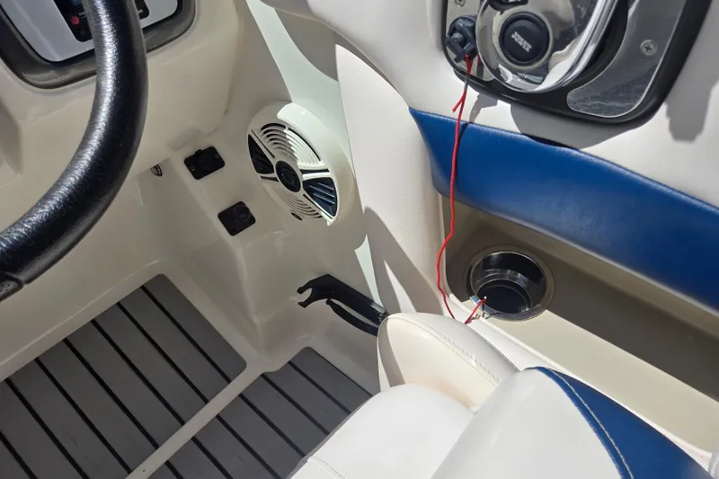 Slide: The Image of Interior of 2010 Chaparral Sunesta 224 boat, featuring steering wheel and audio system. - 28