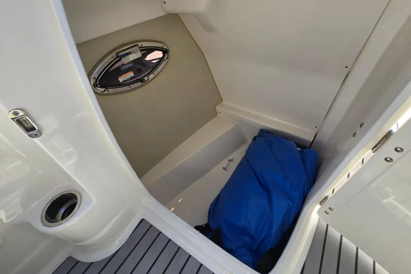 Slide: The Image of Interior storage compartment of 2010 Chaparral Sunesta 224 boat with blue cover. - 29