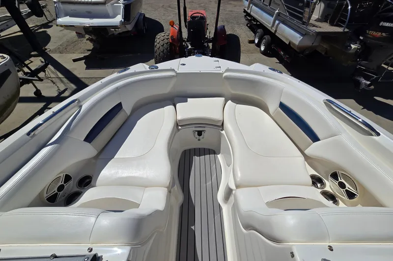 Slide: The Image of 2010 Chaparral Sunesta 224 boat interior with white seating and speakers. - 30
