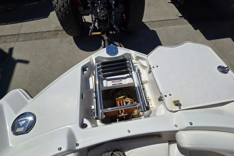 Slide: The Image of 2010 Chaparral Sunesta 224 boat with open storage compartment and ladder. - 31