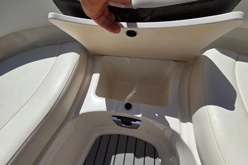 Slide: The Image of 2010 Chaparral Sunesta 224 boat storage compartment with open seat lid. - 32