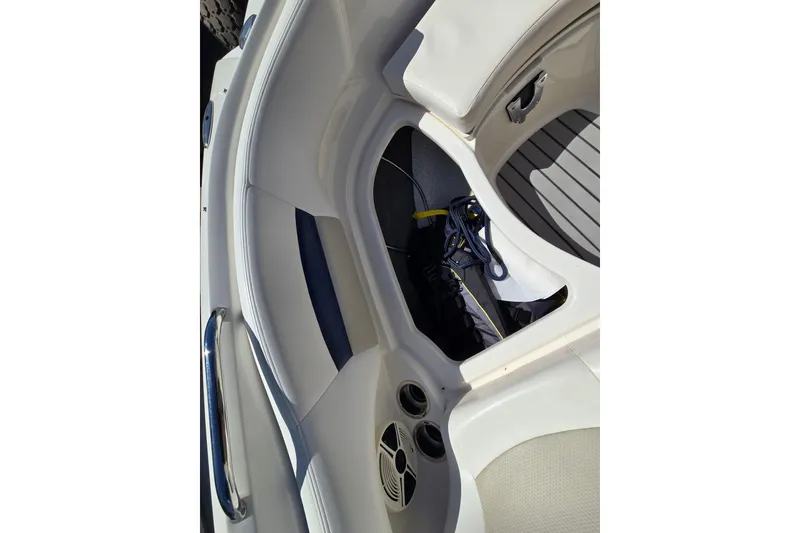 Slide: The Image of 2010 Chaparral Sunesta 224 boat interior with storage compartment and seating. - 33