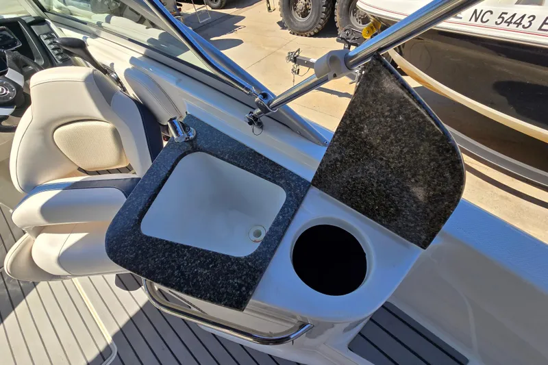 Slide: The Image of 2010 Chaparral Sunesta 224 boat interior with sink and seating area. - 35