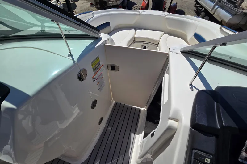 Slide: The Image of 2010 Chaparral Sunesta 224 boat interior with open door and seating area. - 37