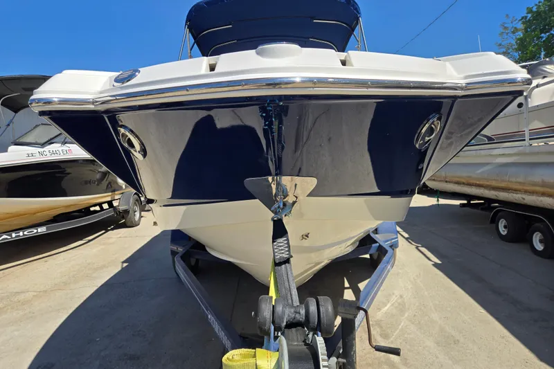 Slide: The Image of 2010 Chaparral Sunesta 224 boat on trailer, front view, blue and white hull. - 4