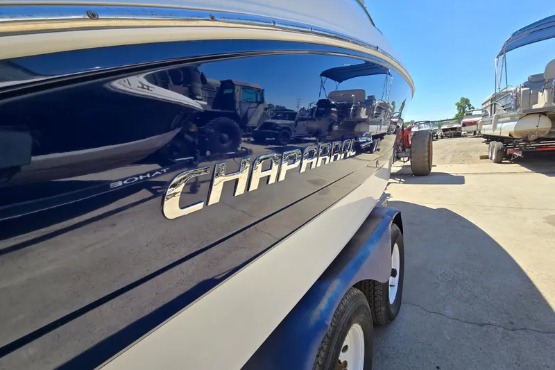 Slide: The Image of 2010 Chaparral Sunesta 224 boat on trailer, reflecting surroundings in glossy finish. - 5