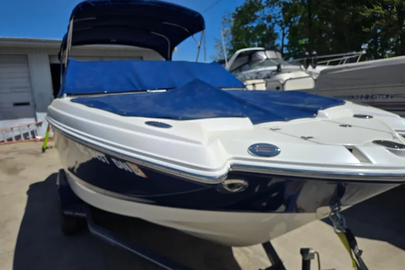 Slide: The Image of 2010 Chaparral Sunesta 224 boat with blue cover, parked outdoors. - 9