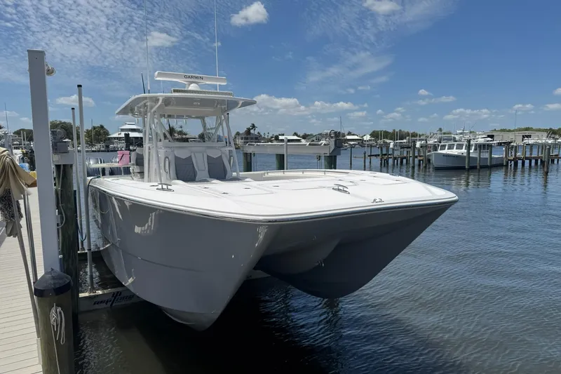 The Image of 2024 Invincible 35 Catamaran docked at marina under blue sky. - 0