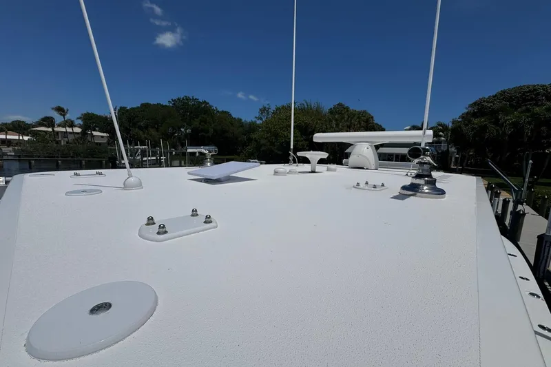 Slide: The Image of Rooftop view of 2024 Invincible 35 Catamaran under clear blue sky. - 10