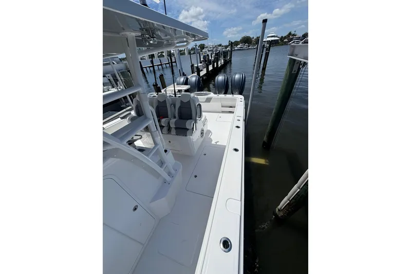 Slide: The Image of 2024 Invincible 35 Catamaran docked, showcasing sleek design and dual engines. - 11