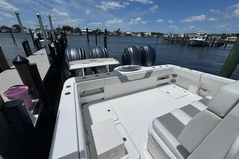 Slide: The Image of 2024 Invincible 35 Catamaran docked, showcasing spacious deck and powerful engines. - 13