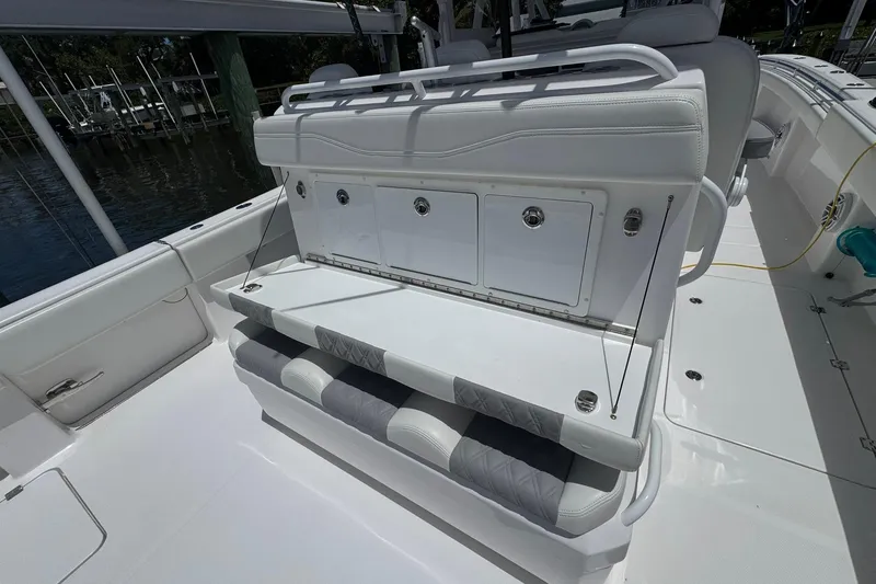 Slide: The Image of 2024 Invincible 35 Catamaran interior with white seating and storage compartments. - 15