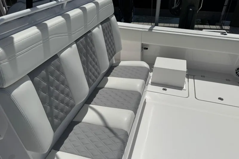 Slide: The Image of 2024 Invincible 35 Catamaran interior with quilted seating and sleek white design. - 16