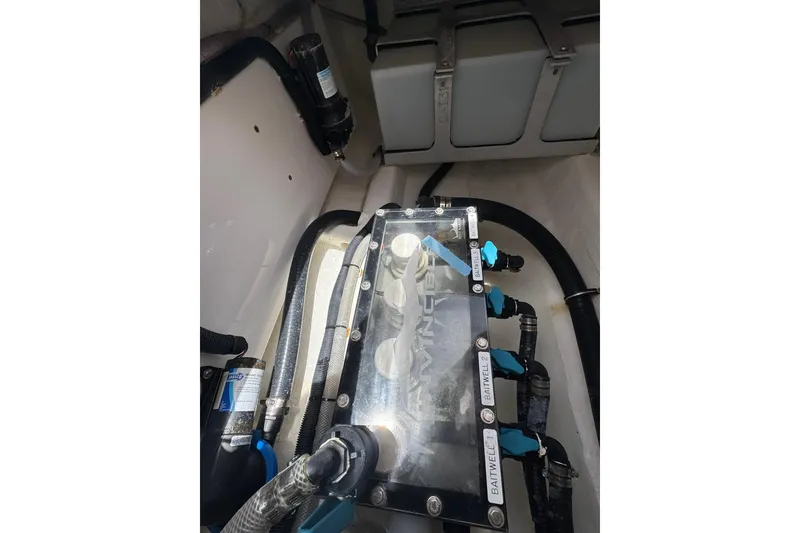 Slide: The Image of Engine compartment of 2024 Invincible 35 Catamaran showcasing mechanical components and wiring. - 20