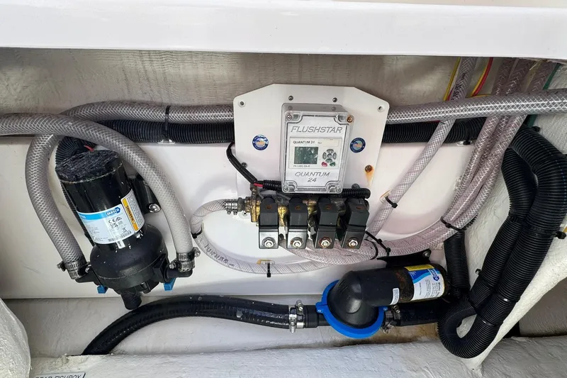 Slide: The Image of Engine compartment of 2024 Invincible 35 Catamaran with plumbing and electrical components. - 21