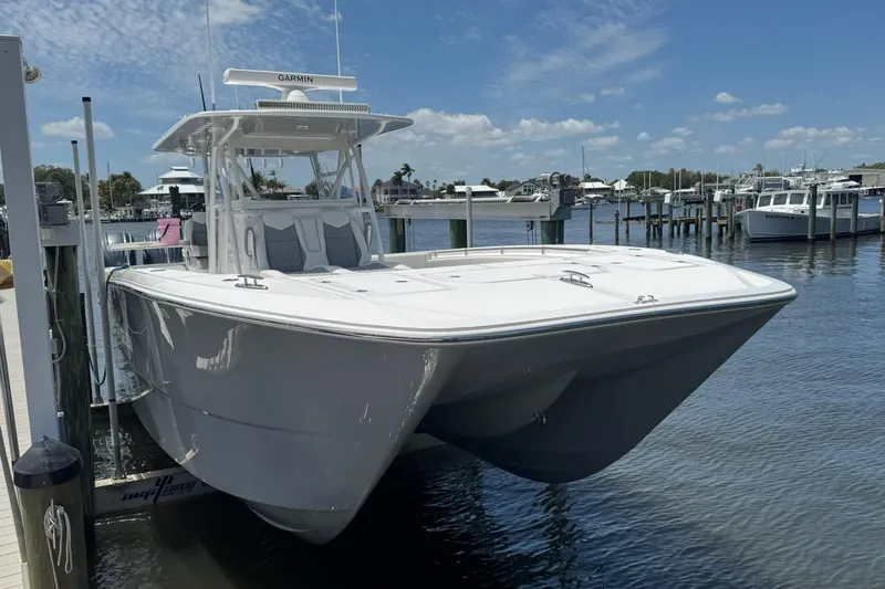 Slide: The Image of 2024 Invincible 35 Catamaran docked at marina under clear blue sky. - 25
