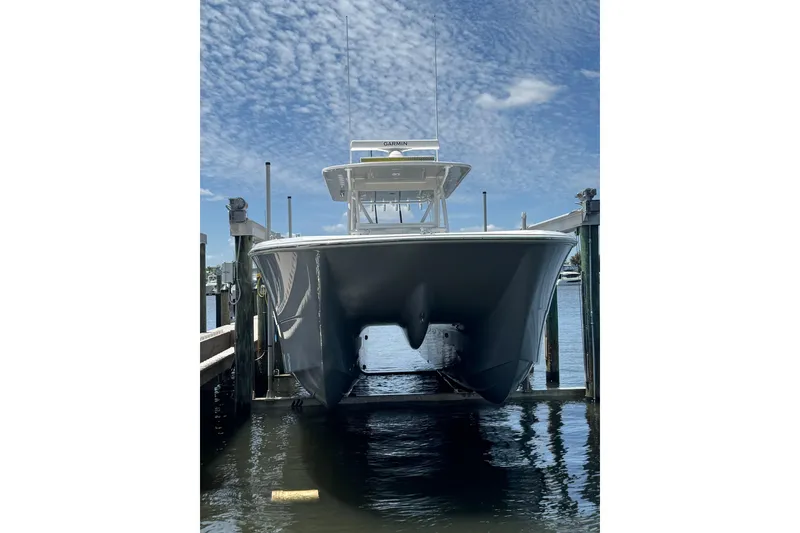 Slide: The Image of 2024 Invincible 35 Catamaran docked, showcasing sleek design under a blue sky. - 27