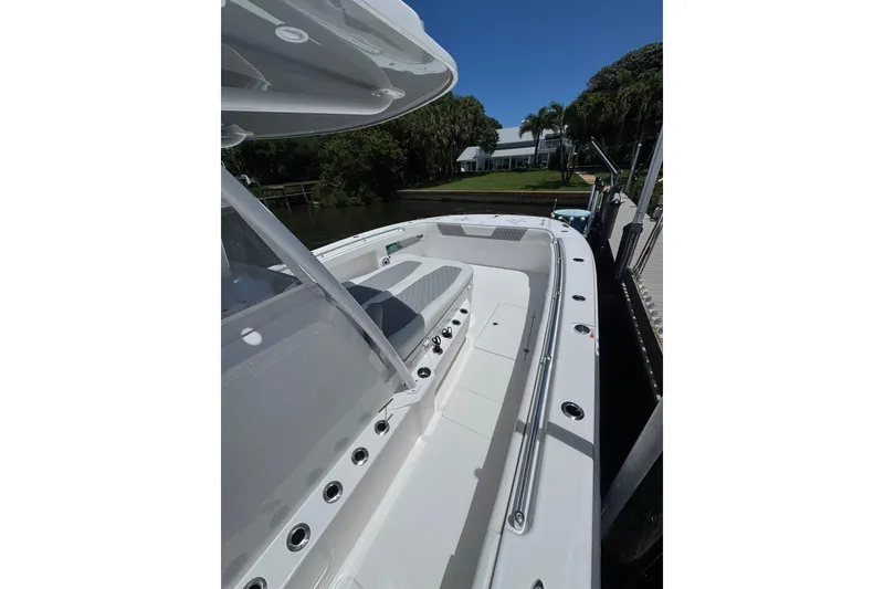 Slide: The Image of 2024 Invincible 35 Catamaran docked, showcasing spacious deck and sleek design. - 8