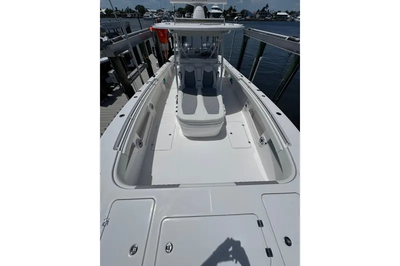 Slide: The Image of 2024 Invincible 35 Catamaran, sleek white deck, docked at marina. - 9