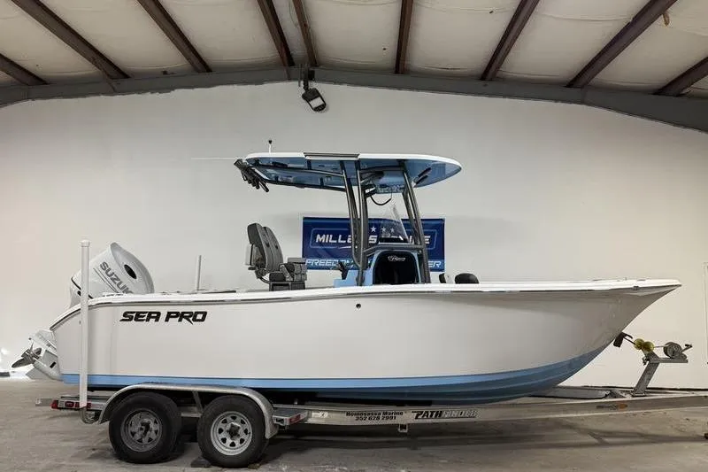The Image of 2026 Sea Pro 222 Center Console boat on trailer in indoor showroom. - 0