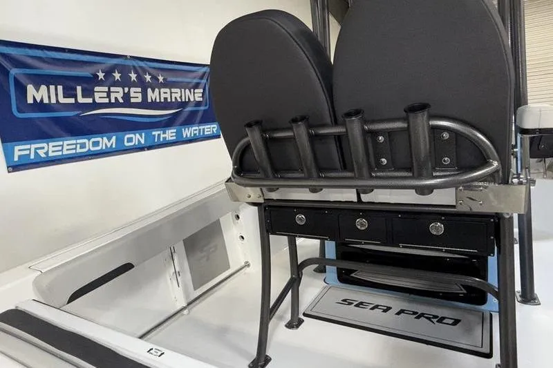 Slide: The Image of 2026 Sea Pro 222 Center Console interior with rod holders and seating, Miller's Marine banner. - 11