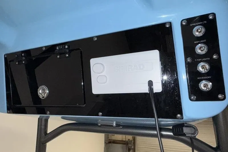 Slide: The Image of Control panel of 2026 Sea Pro 222 Center Console boat with switches and Simrad device. - 14