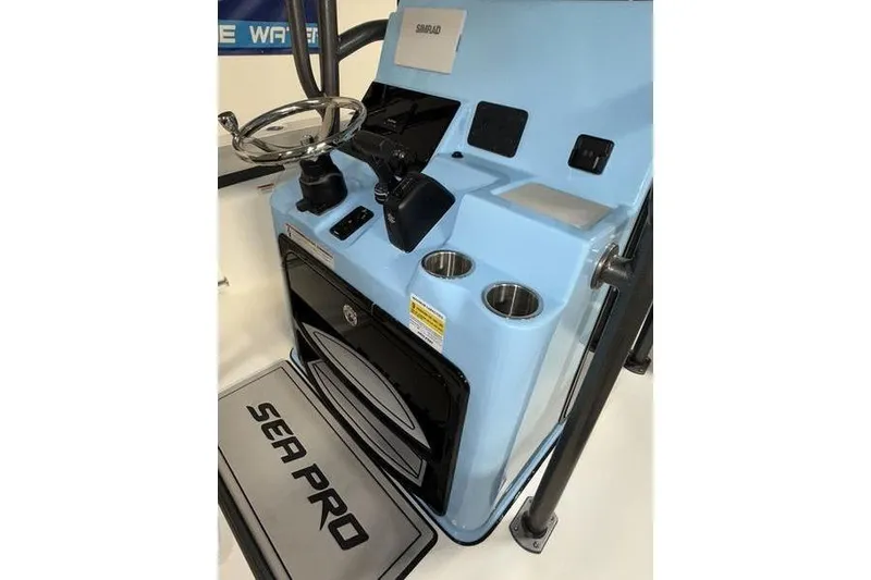 Slide: The Image of 2026 Sea Pro 222 Center Console boat dashboard with steering wheel and controls. - 15