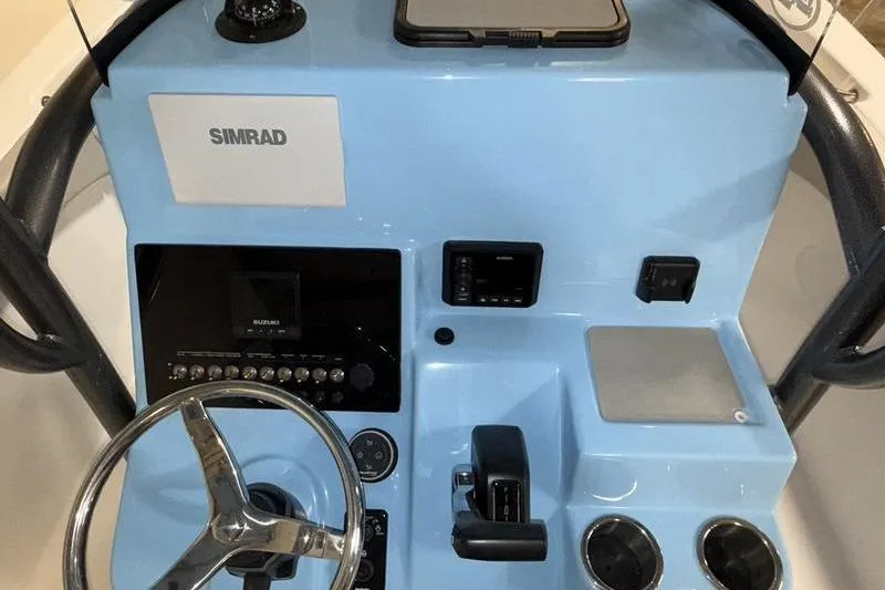 Slide: The Image of 2026 Sea Pro 222 Center Console dashboard with steering wheel and Simrad electronics. - 16