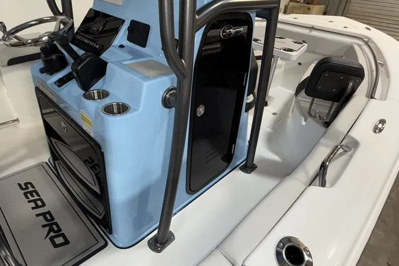 Slide: The Image of 2026 Sea Pro 222 Center Console boat interior with blue console and seating area. - 17