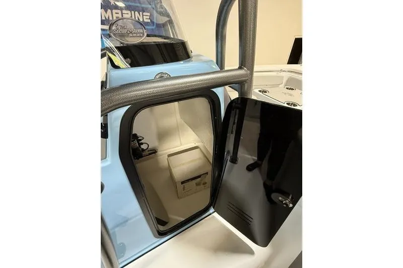 Slide: The Image of 2026 Sea Pro 222 Center Console boat interior storage compartment with open door. - 18