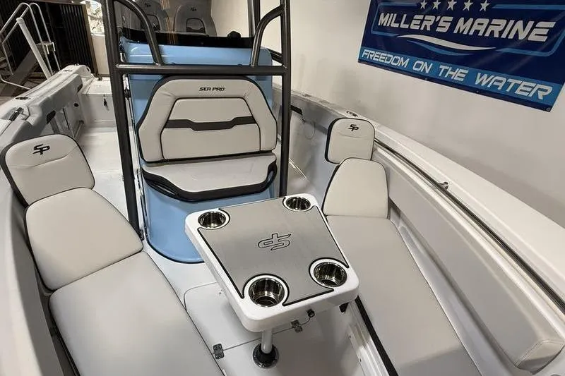 Slide: The Image of 2026 Sea Pro 222 Center Console boat interior with seating and table at Miller's Marine. - 22