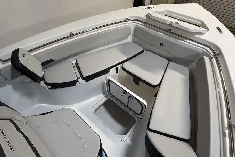 Slide: The Image of 2026 Sea Pro 222 Center Console boat interior with cushioned seating and storage compartments. - 24