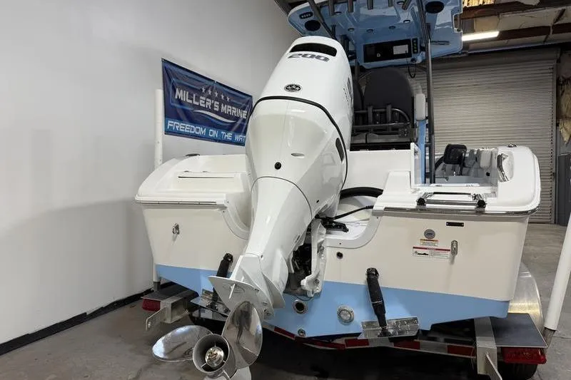 Slide: The Image of 2026 Sea Pro 222 Center Console boat with powerful outboard motor in showroom. - 5