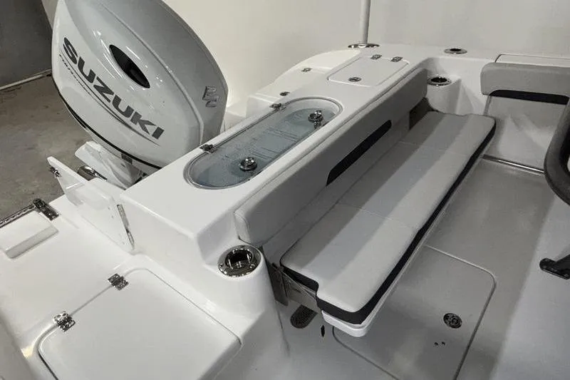 Slide: The Image of 2026 Sea Pro 222 Center Console boat interior with Suzuki engine, featuring seating and storage compartments. - 8