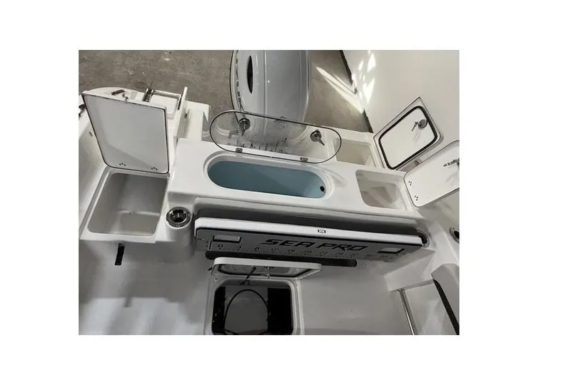 Slide: The Image of 2026 Sea Pro 222 Center Console boat interior with storage compartments and livewell. - 9