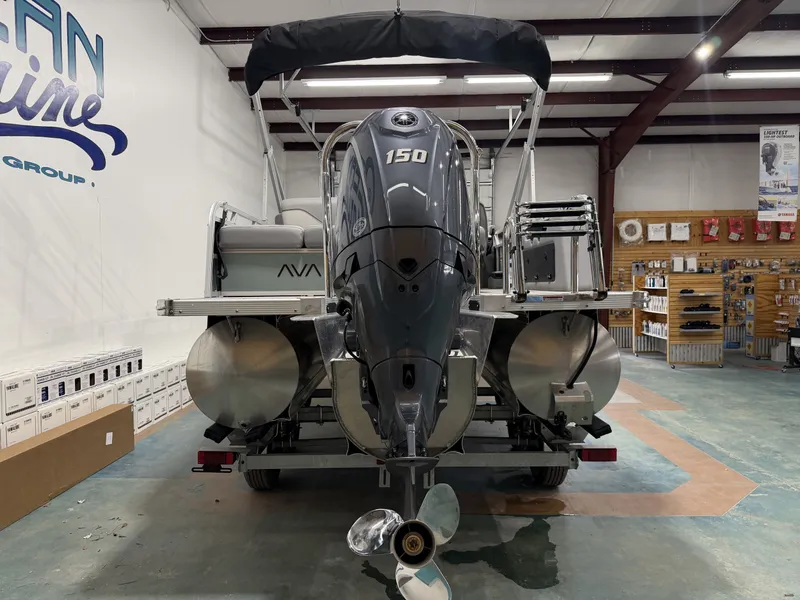 Slide: The Image of Avalon VNT VRB21T 2026 pontoon boat in showroom with outboard motor. - 3