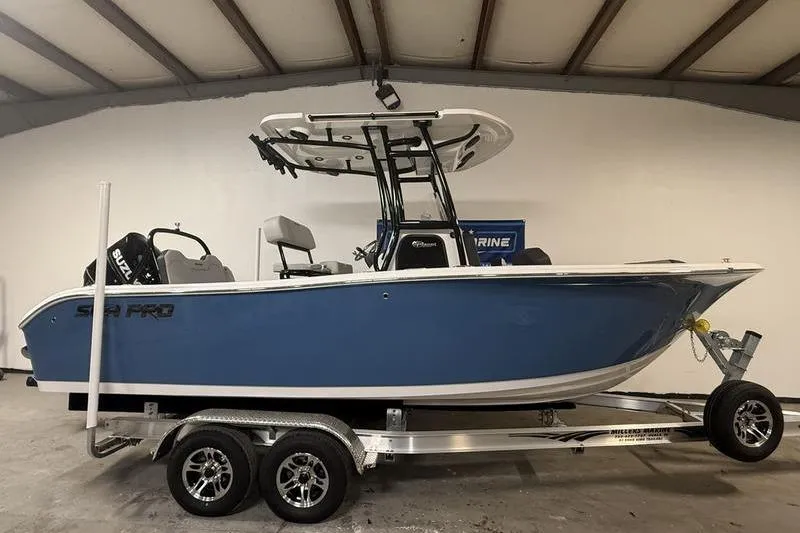 The Image of 2026 Sea Pro 225 FLXR Sandbar boat on trailer in indoor showroom. - 0