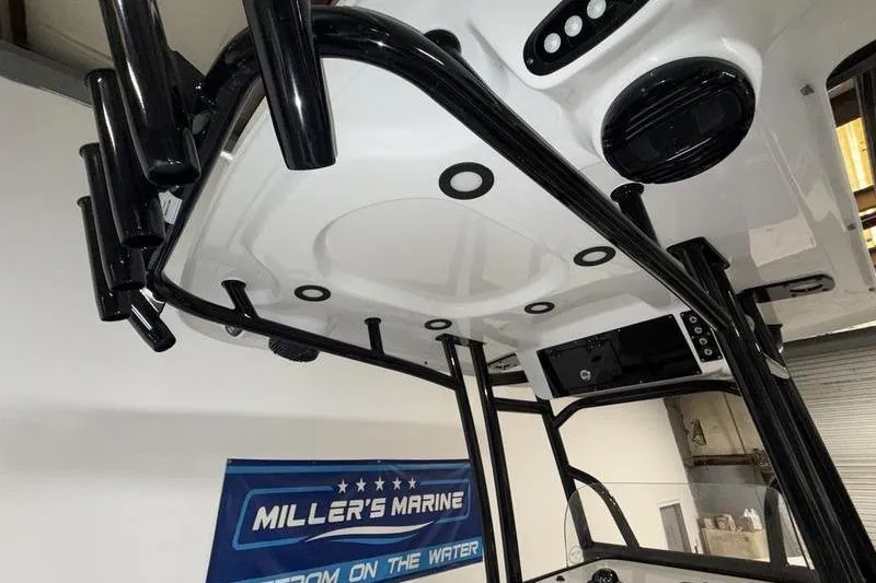 Slide: The Image of 2026 Sea Pro 225 FLXR Sandbar boat interior with rod holders and electronics. - 12