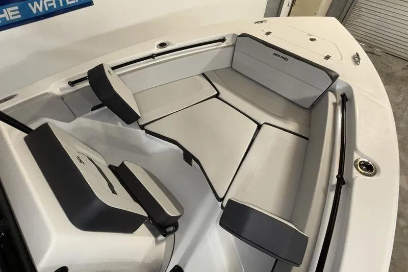Slide: The Image of 2026 Sea Pro 225 FLXR Sandbar boat interior with cushioned seating and sleek design. - 16