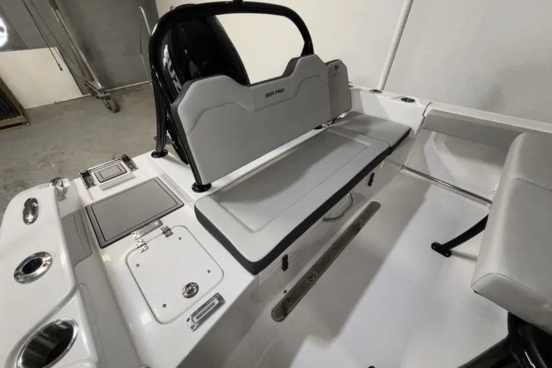 Slide: The Image of 2026 Sea Pro 225 FLXR Sandbar boat interior with seating and storage compartments. - 4