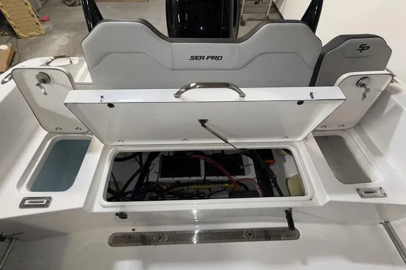 Slide: The Image of 2026 Sea Pro 225 FLXR Sandbar boat interior with open storage compartment. - 5