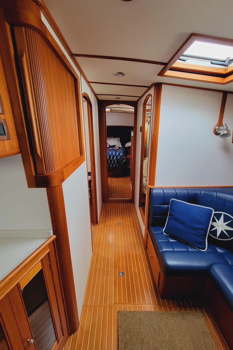 Slide: The Image of Interior of 2004 Grand Banks 49 Eastbay HX with wood floors and blue couch. - 18