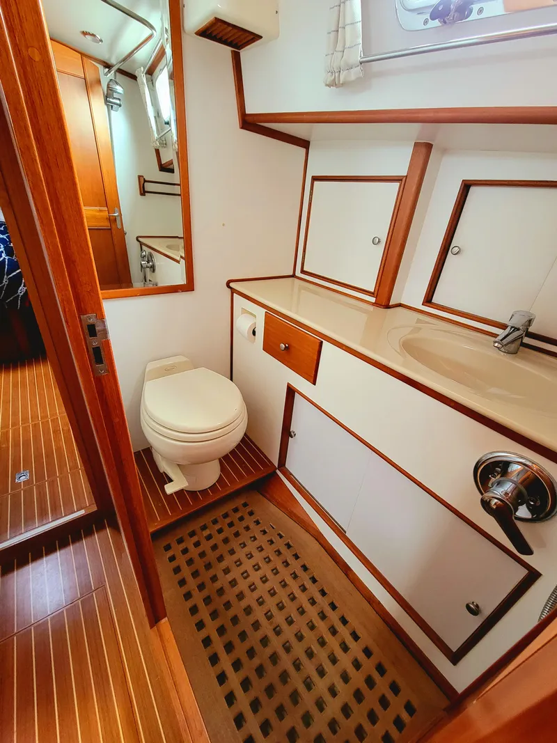 Slide: The Image of Interior of 2004 Grand Banks 49 Eastbay HX, bathroom with wooden accents. - 26