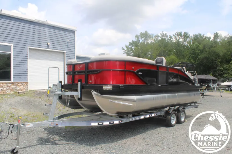 The Image of 2025 Barletta Cabrio C20UC pontoon boat on trailer outside building. - 1