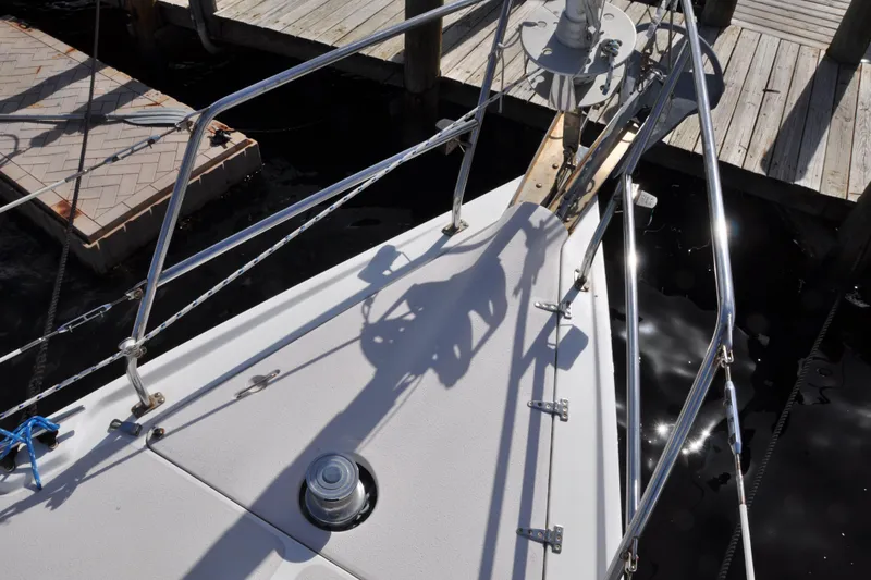 Slide: The Image of Bow of 2003 Catalina 387 sailboat docked, featuring stainless steel railings and deck fittings. - 11