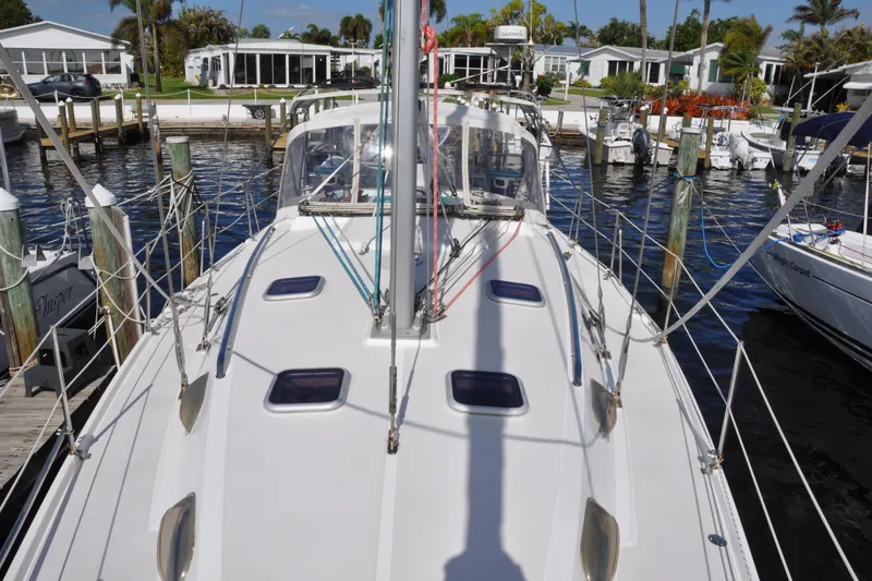 Slide: The Image of Catalina 387 sailboat docked at marina, showcasing deck and rigging, 2003 model. - 13