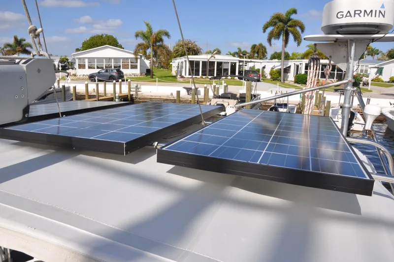Slide: The Image of Solar panels on a 2003 Catalina 387 sailboat, docked near waterfront homes. - 17